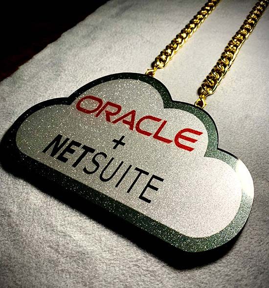 Oracle NetSuite cloud pendant on a gold chain.