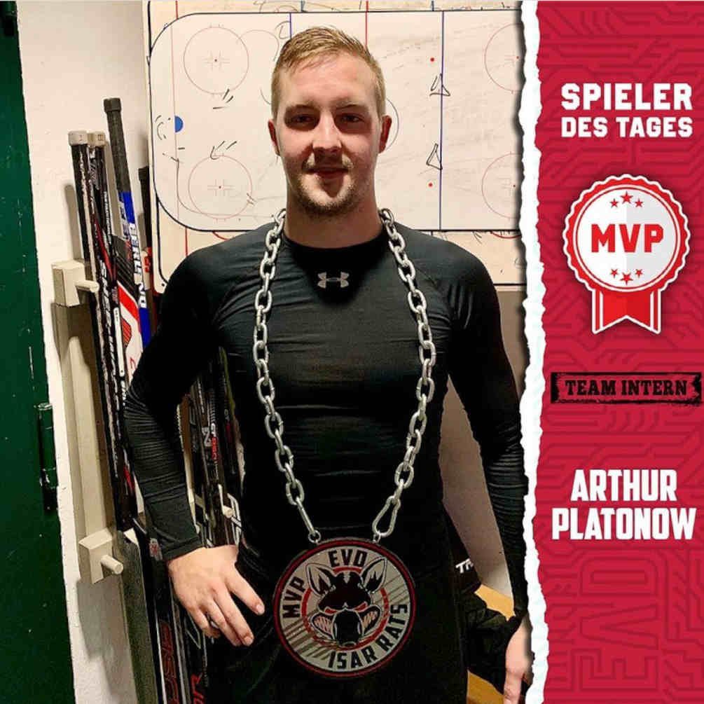 Player wearing an MVP chain in a locker-room photo.