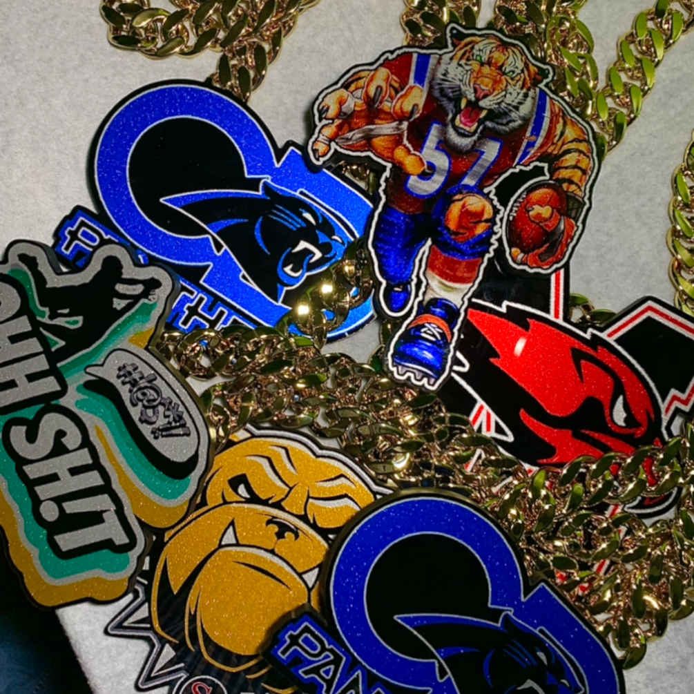 Stacked mix of custom team pendants and chain styles.