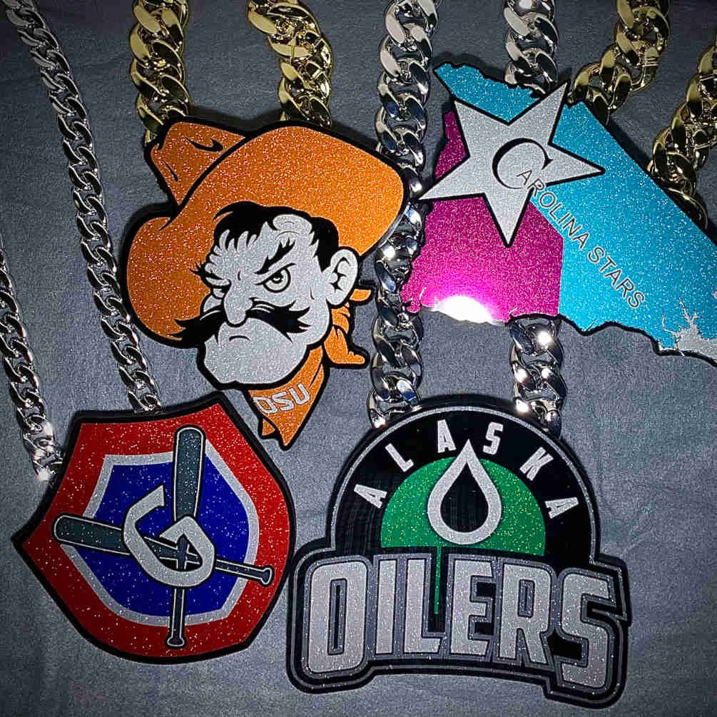 Mixed team pendants on silver and gold chains.