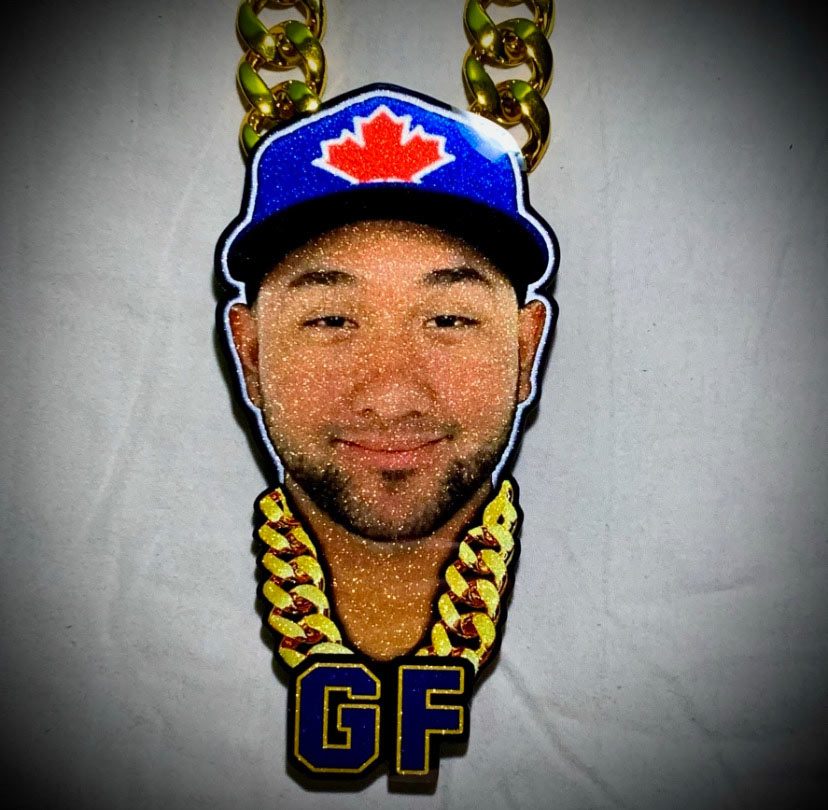 Photo-face pendant with blue cap, gold chain, and GF letters.