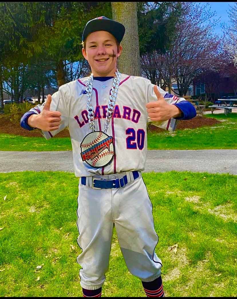 Youth baseball player wearing a Lions baseball chain.