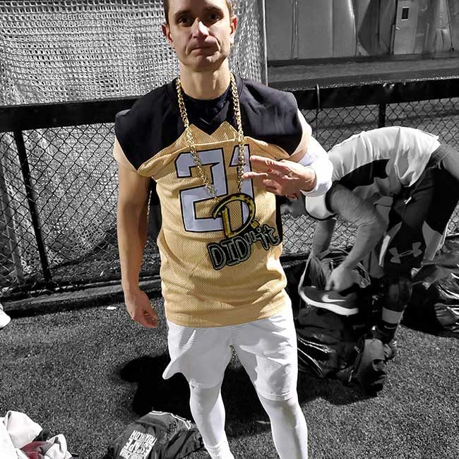 Football player wearing a Did It chain and number 24 jersey.