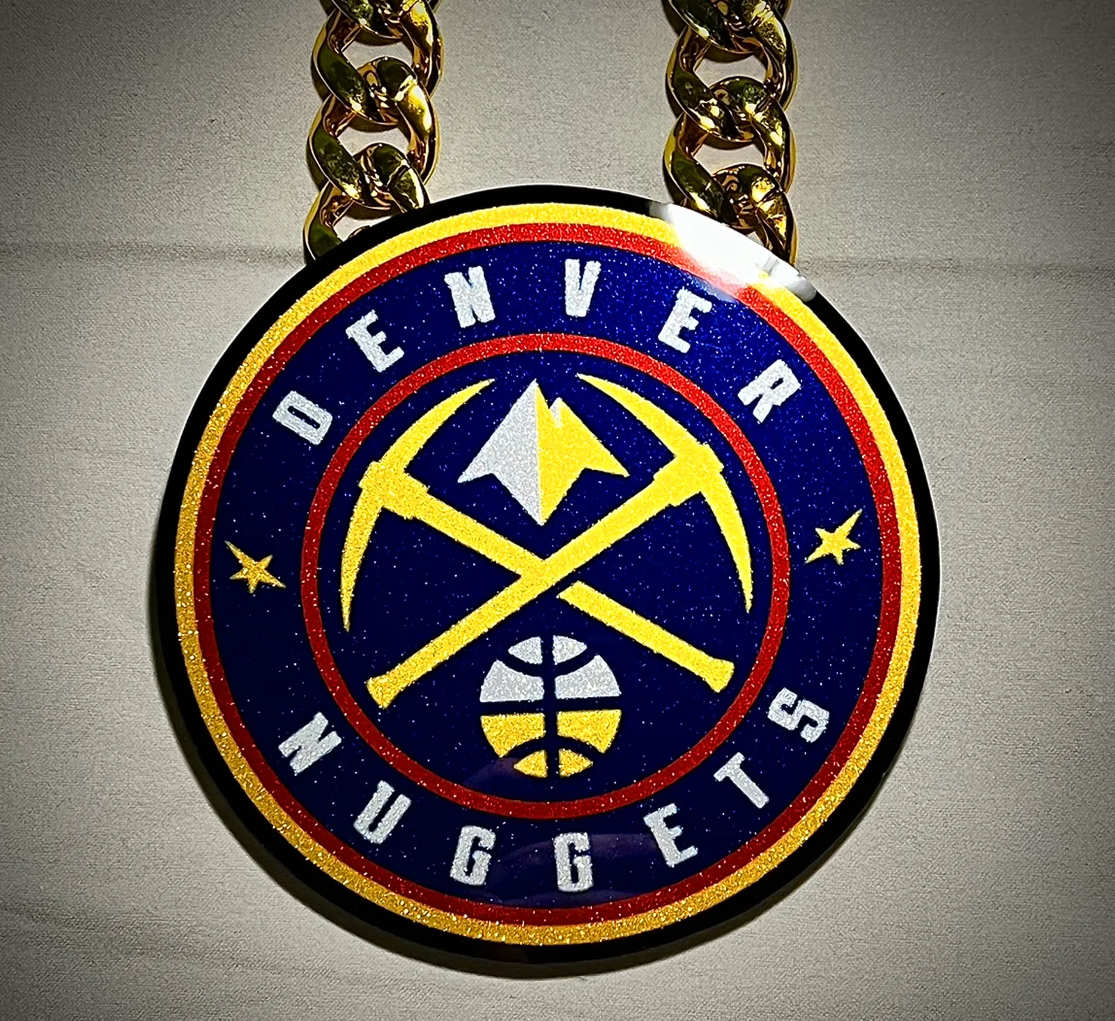 Round basketball pendant inspired by Denver colors.