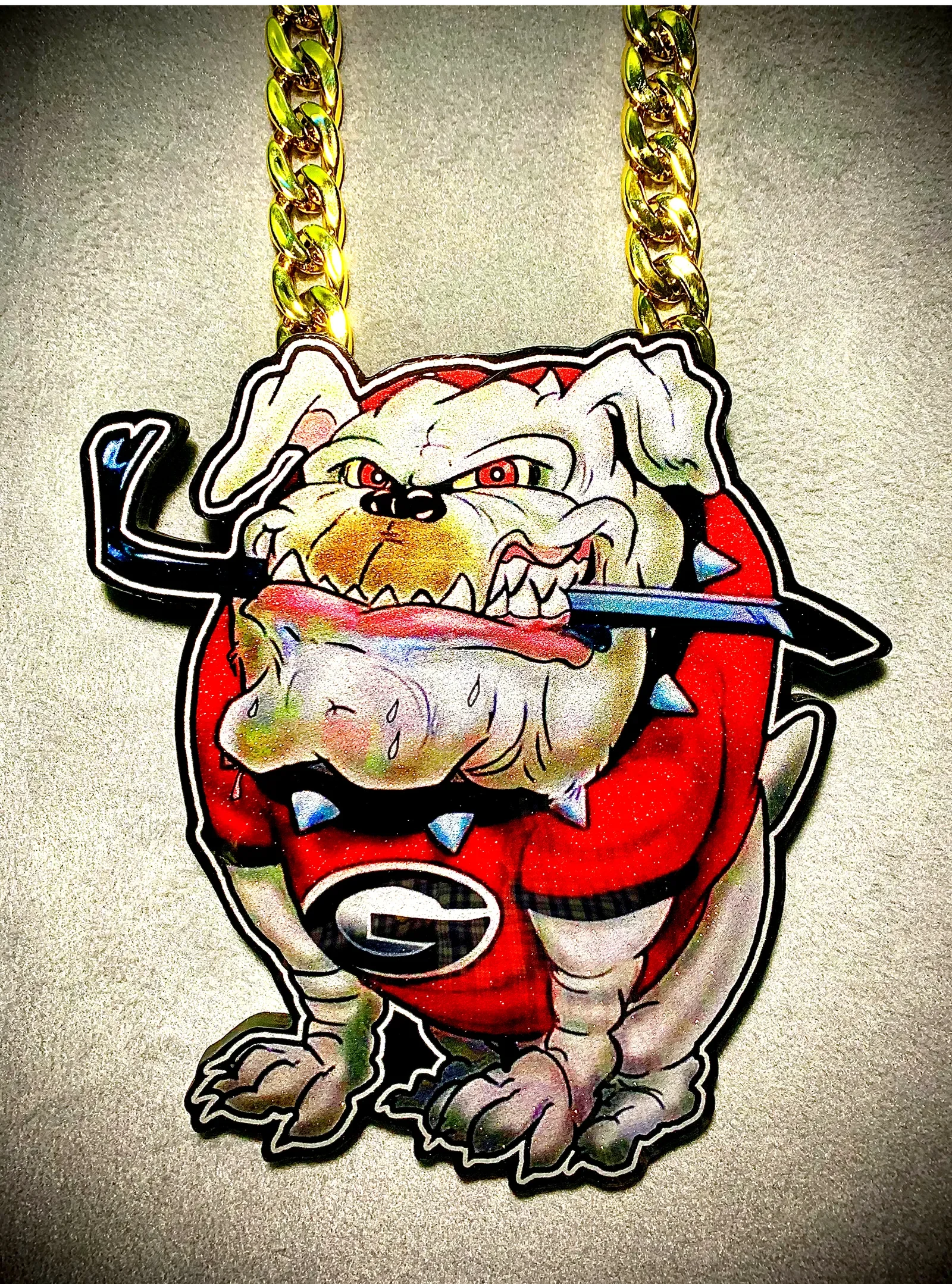 Polished close-up of a custom football pendant on chain.