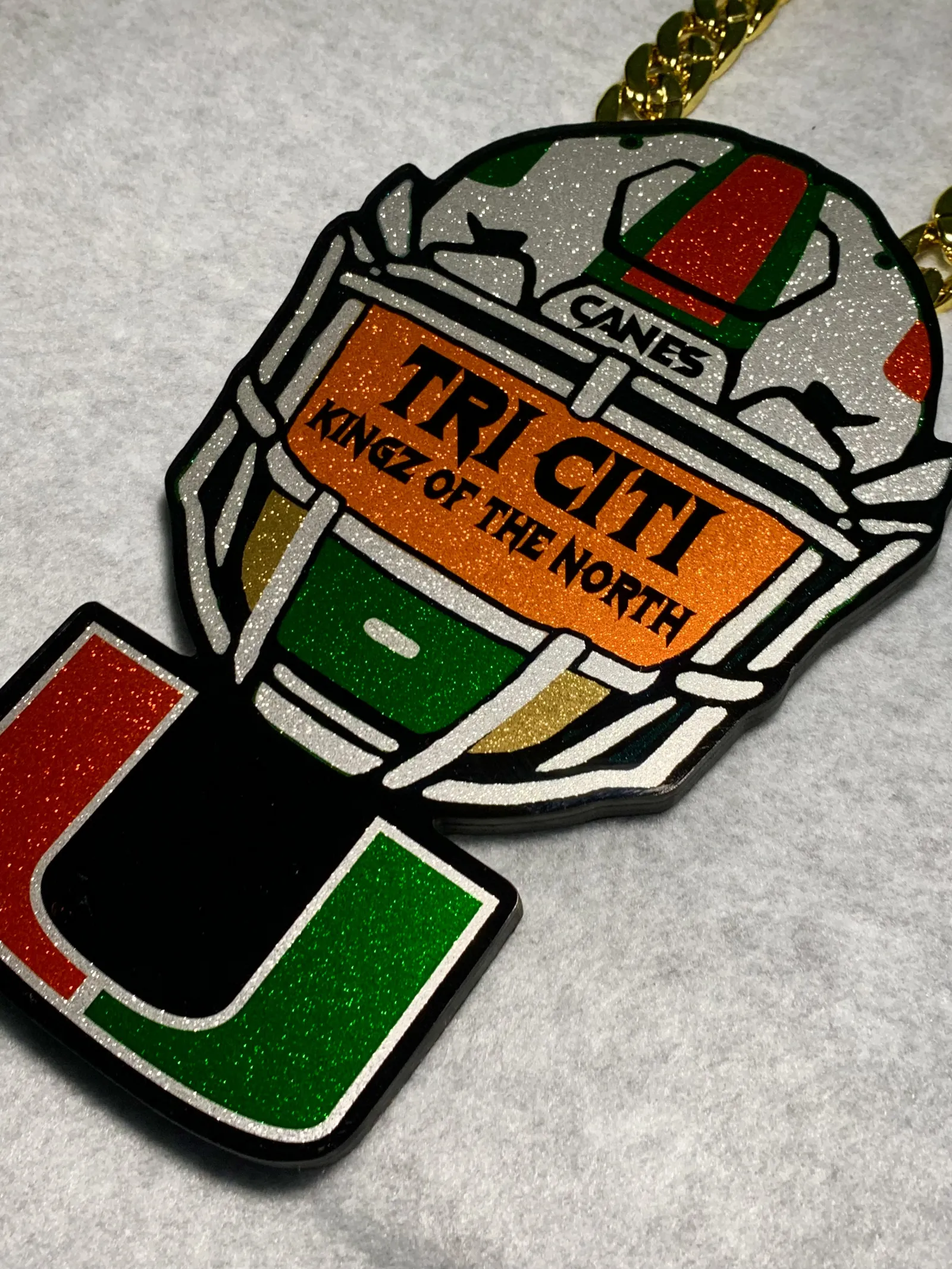 Miami Hurricanes style turnover chain pendant.